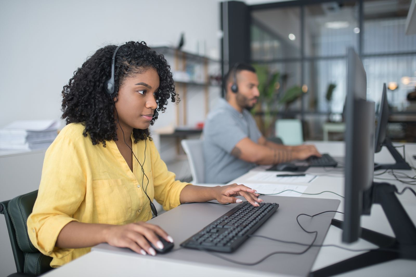 A customer support agent on a call at her desk