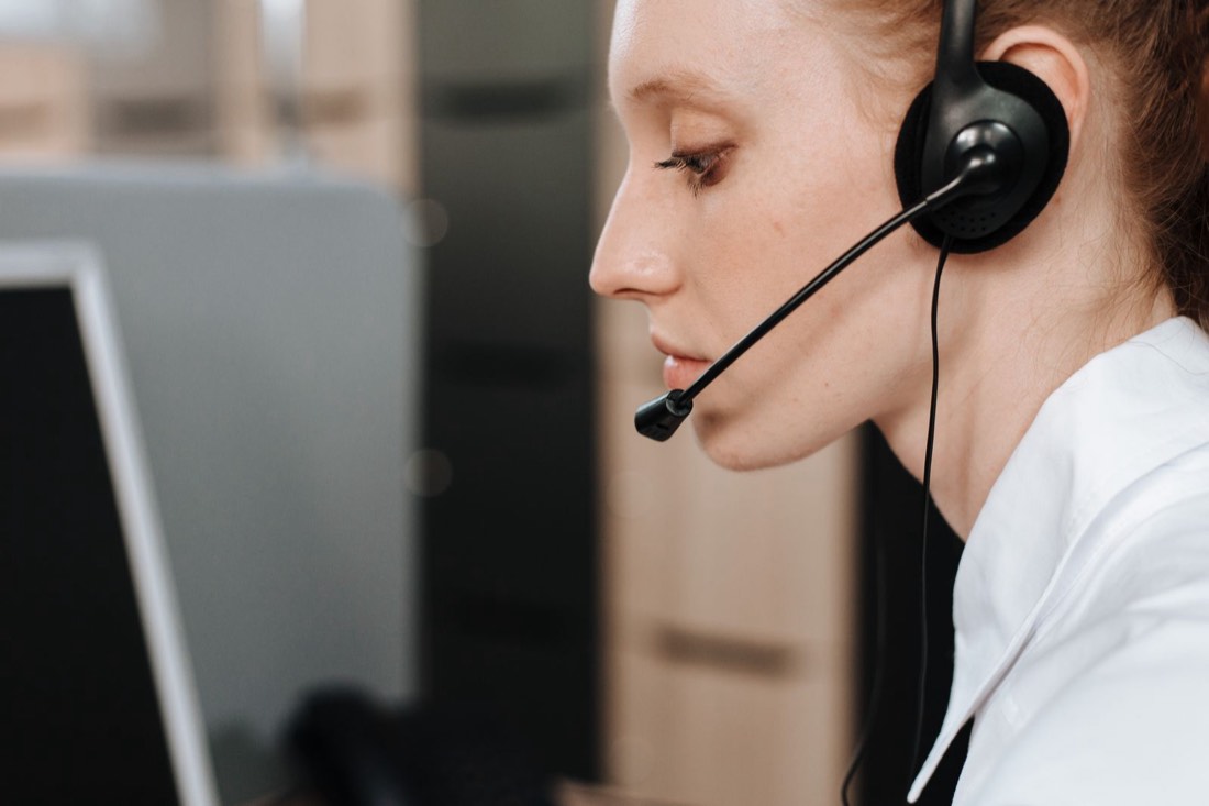 An agent with a headset on a call